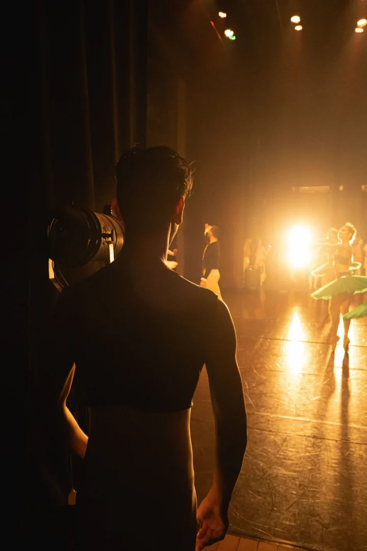 A person looking at a stage from backstage.