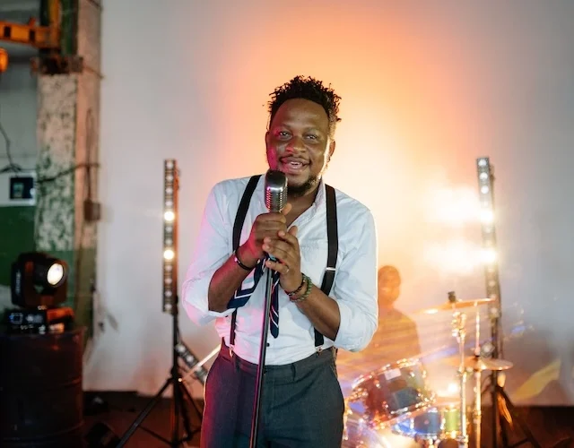 A guy singing into a microphone.