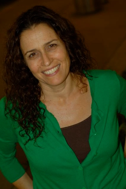 A photo of Heidi smiling in a green top.